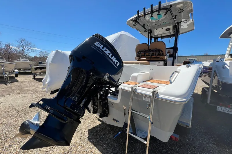 Slide: The Image of 2021 Sea Pro 239 Center Console boat with Suzuki outboard motor, docked outdoors. - 2