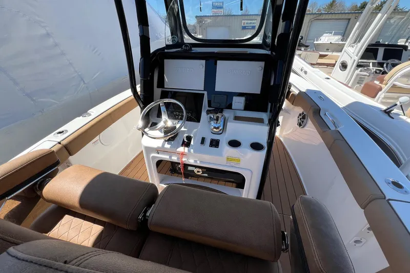 Slide: The Image of 2021 Sea Pro 239 Center Console boat interior with steering wheel and controls. - 4