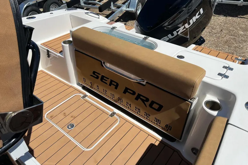 Slide: The Image of 2021 Sea Pro 239 Center Console boat interior with Suzuki engine, featuring teak flooring. - 6