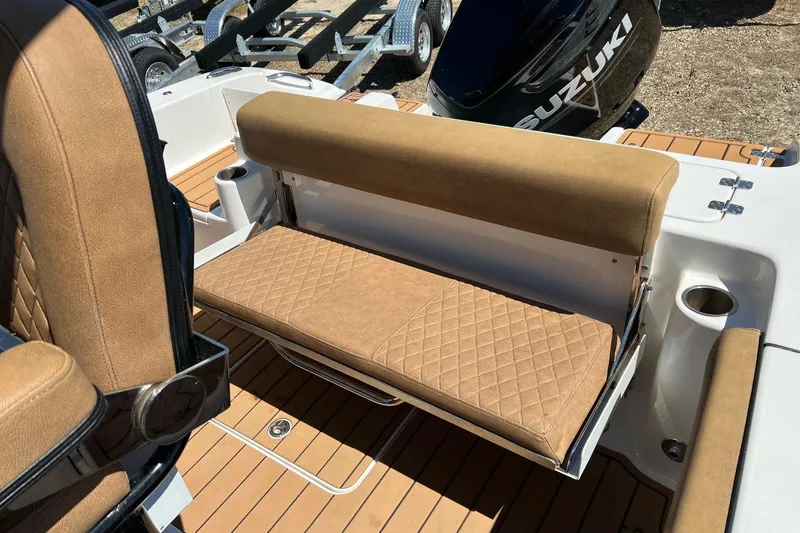 Slide: The Image of 2021 Sea Pro 239 Center Console boat with tan cushioned seating and Suzuki engine. - 7