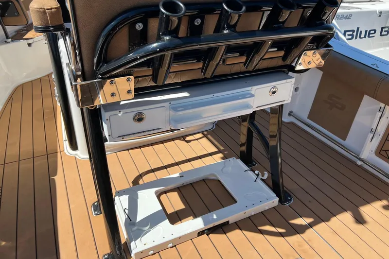 Slide: The Image of 2021 Sea Pro 239 Center Console boat interior with rod holders and teak flooring. - 9