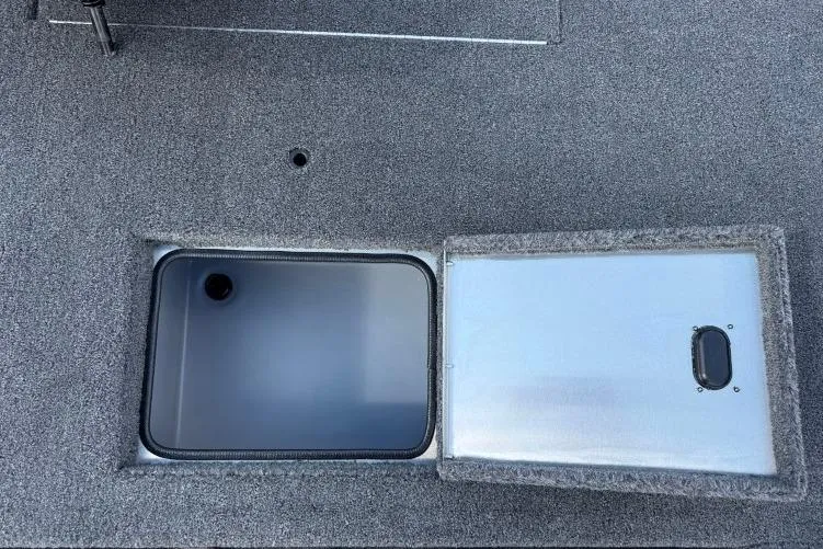 Slide: The Image of Open storage compartment on 2026 Crestliner 1700 Storm boat deck. - 12