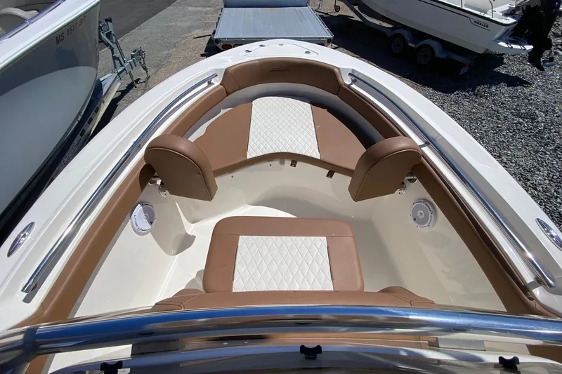 Slide: The Image of 2023 Pioneer 202 Sportfish boat interior with cushioned seating and stainless steel railings. - 15