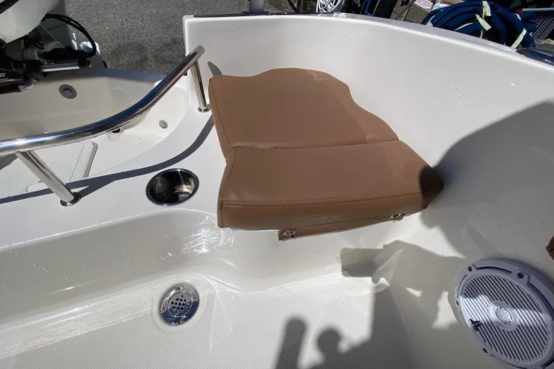 Slide: The Image of Brown seat on 2023 Pioneer 202 Sportfish boat, featuring stainless steel cup holder and speaker. - 18