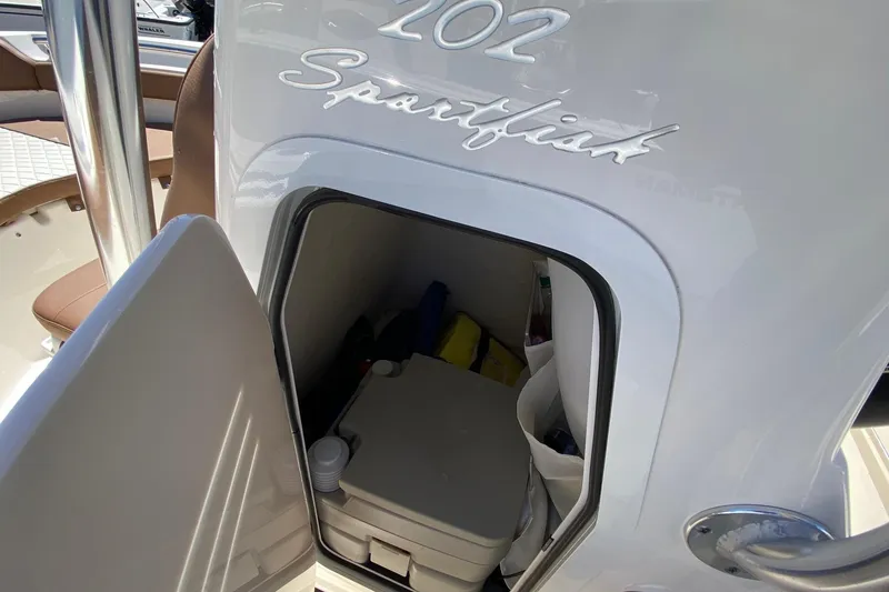 Slide: The Image of 2023 Pioneer 202 Sportfish boat interior storage compartment with open door. - 19