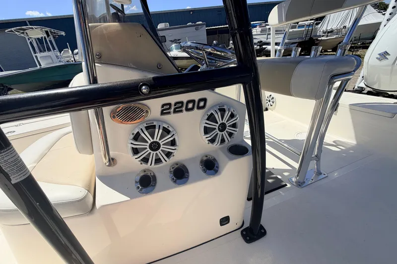 Slide: The Image of 2021 Bulls Bay 2200 boat interior with speakers and seating, showcasing modern design. - 11
