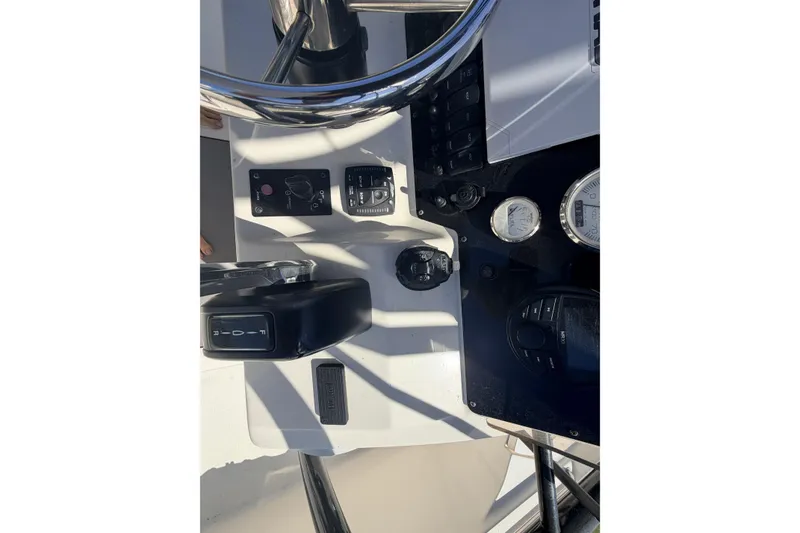 Slide: The Image of 2021 Bulls Bay 2200 boat dashboard with steering wheel and control panel. - 13
