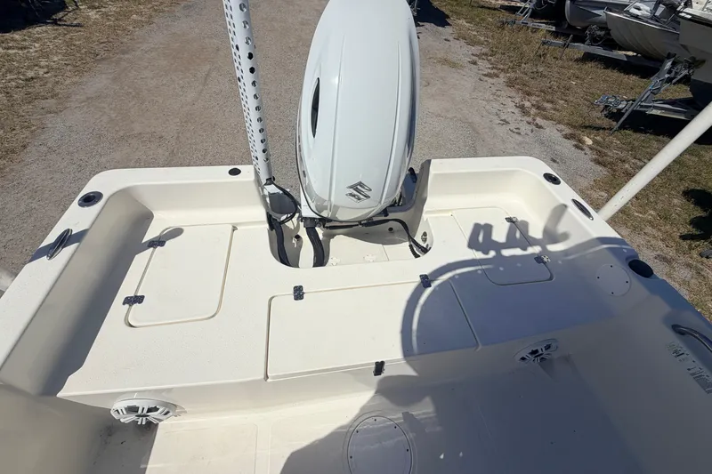 Slide: The Image of 2021 Bulls Bay 2200 boat deck with outboard motor, storage compartments, and speaker. - 14