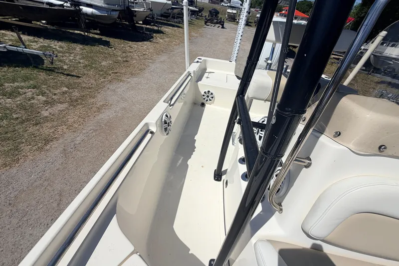 Slide: The Image of 2021 Bulls Bay 2200 boat interior with seating and railings, parked on gravel. - 15