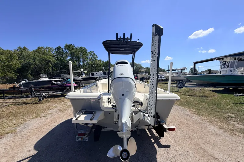 Slide: The Image of 2021 Bulls Bay 2200 boat with outboard motor, parked outdoors under clear blue sky. - 3