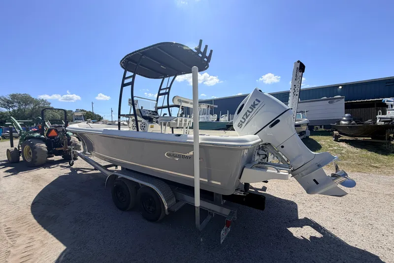Slide: The Image of 2021 Bulls Bay 2200 boat with Suzuki outboard motor on trailer, sunny day. - 4
