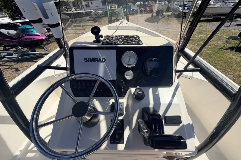 Slide: The Image of 2021 Bulls Bay 2200 boat dashboard with Simrad display and steering wheel. - 5