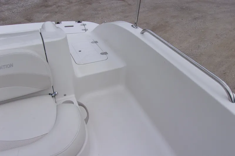 Slide: The Image of Interior of a 2004 Stardeck 201 boat, featuring white seating and storage compartments. - 10