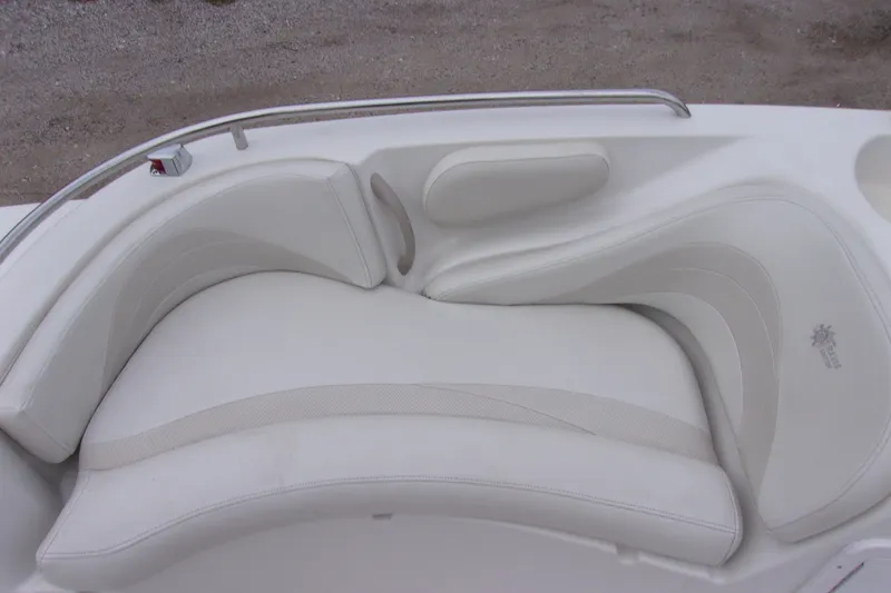 Slide: The Image of White cushioned seating on a 2004 Stardeck 201 boat, featuring elegant design and comfort. - 11