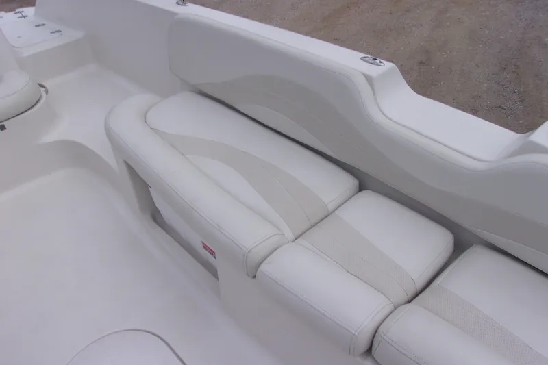 Slide: The Image of White seating area of a 2004 Stardeck 201 boat, featuring cushioned upholstery. - 13