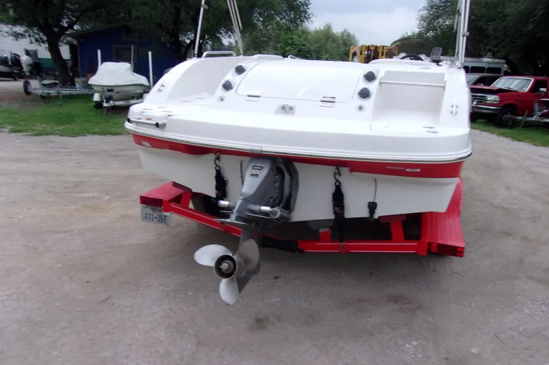 Slide: The Image of Rear view of 2004 Stardeck 201 boat on red trailer, parked outdoors. - 3