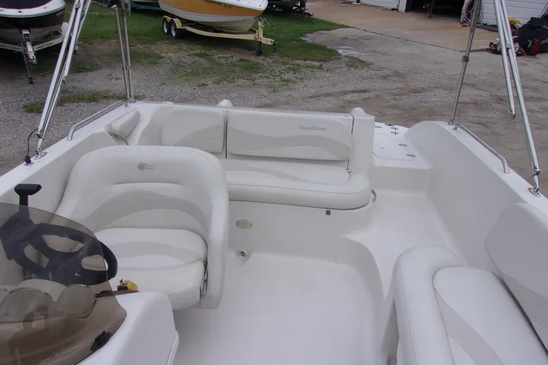 Slide: The Image of 2004 Stardeck 201 boat interior with white seating and steering wheel. - 5