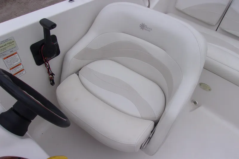 Slide: The Image of White captain's chair in a 2004 Stardeck 201 boat cockpit. - 7