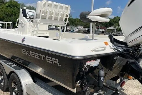 Slide: The Image of 2020 Skeeter SX240 boat on trailer, featuring sleek design and powerful engine. - 4