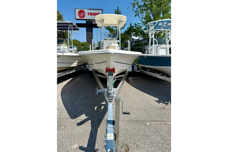 Slide: The Image of 2026 Bulls Bay 2400 boat on trailer, parked outdoors under clear blue sky. - 2