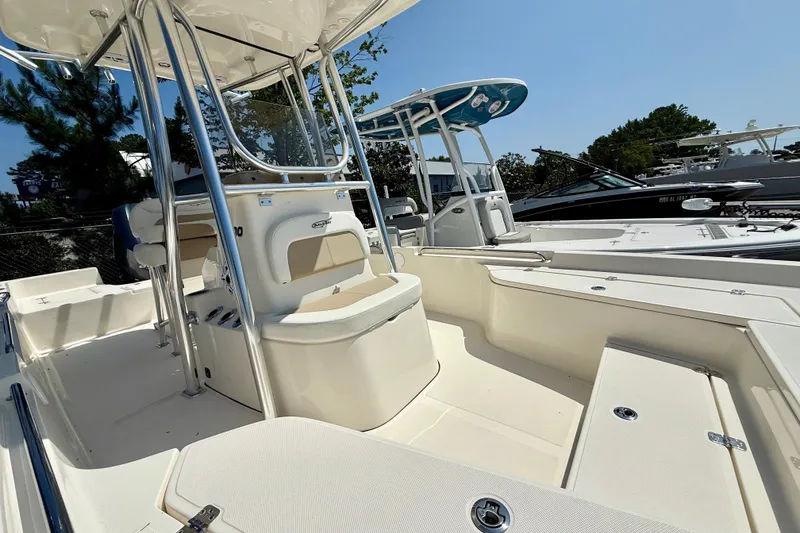 Slide: The Image of 2026 Bulls Bay 2400 boat interior with Garmin navigation system, parked at a dealership. - 7