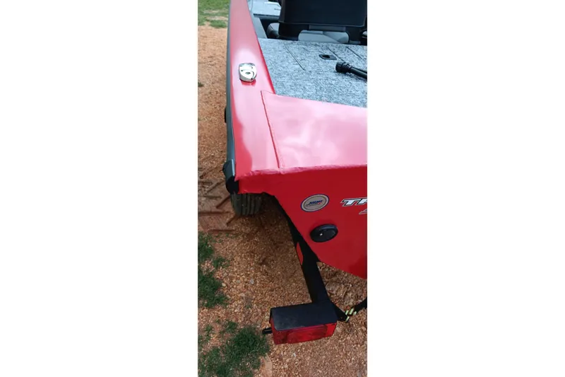 Slide: The Image of Red Tracker Pro Team 175 boat, 2026 model, on a gravel surface. - 14