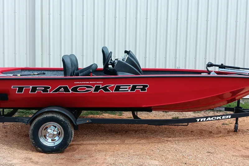 Slide: The Image of Red 2026 Tracker Pro Team 175 boat on trailer, parked outdoors. - 17