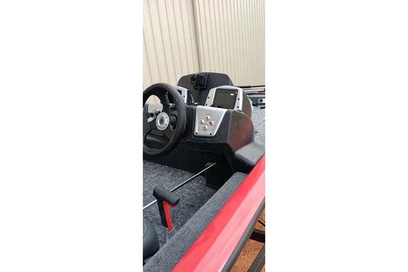 Slide: The Image of 2026 Tracker Pro Team 175 boat dashboard with steering wheel and control panel. - 18