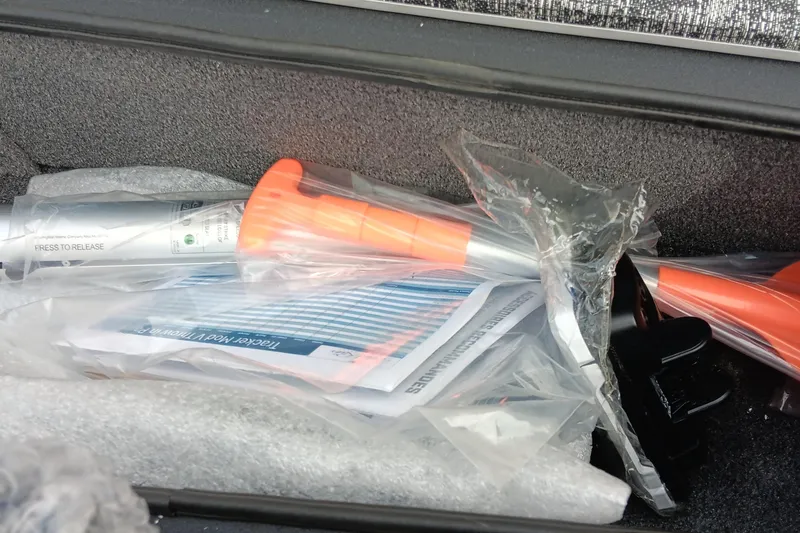 Slide: The Image of Boat equipment and manuals in storage compartment of 2026 Tracker Pro Team 175. - 2