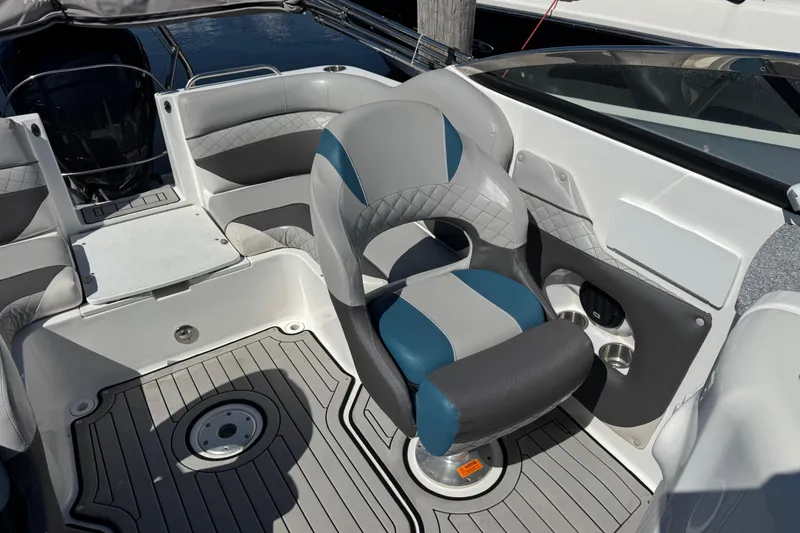 Slide: The Image of 2019 Hurricane SunDeck 2486 OB boat interior with gray and blue seating. - 10