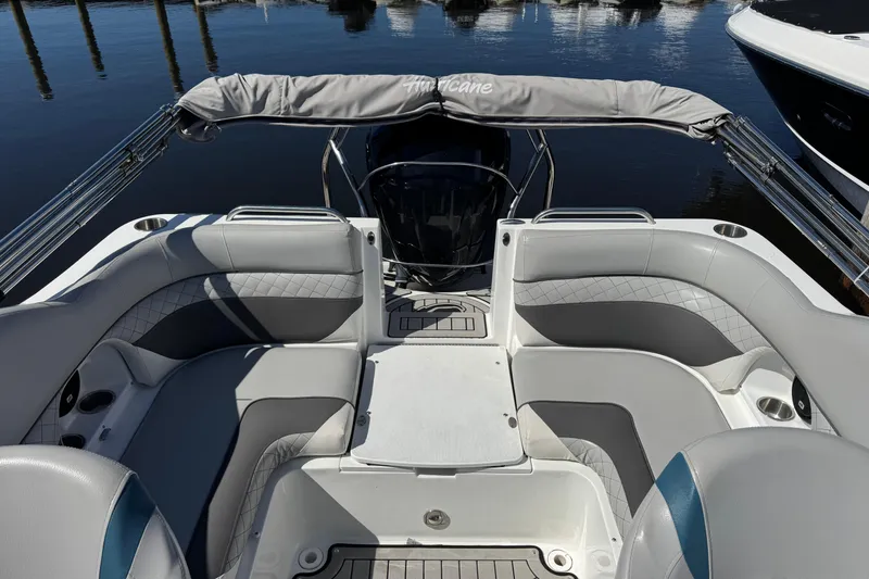 Slide: The Image of 2019 Hurricane SunDeck 2486 OB boat interior with cushioned seating and sleek design. - 11