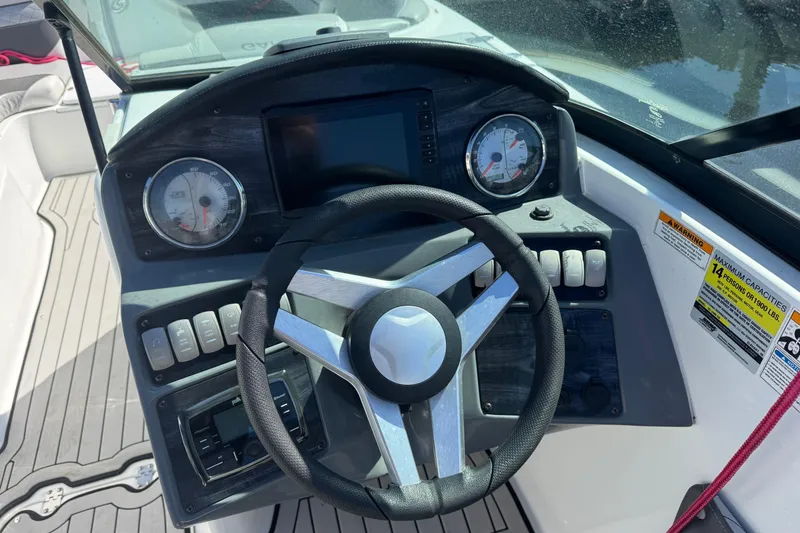 Slide: The Image of 2019 Hurricane SunDeck 2486 OB boat dashboard with steering wheel and gauges. - 13