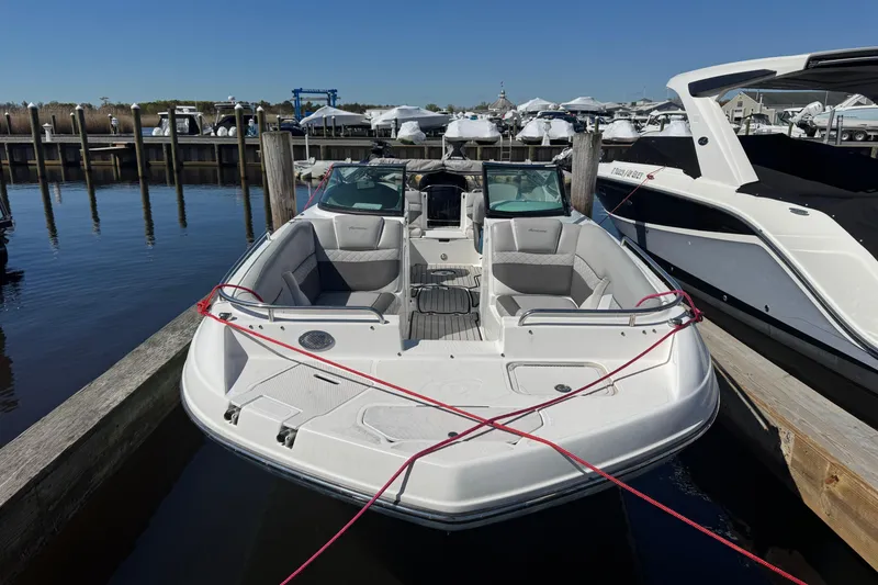 Slide: The Image of 2019 Hurricane SunDeck 2486 OB boat docked at marina, featuring spacious seating and sleek design. - 3