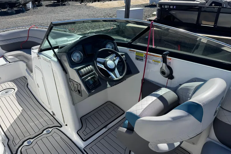 Slide: The Image of 2019 Hurricane SunDeck 2486 OB boat cockpit with steering wheel and seating. - 6