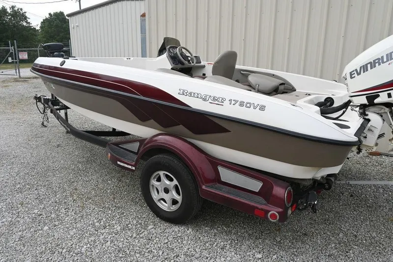 Slide: The Image of 2007 Ranger 1760 Angler boat on trailer, parked on gravel near a building. - 4