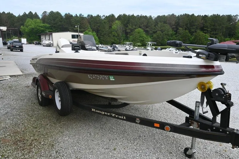 Slide: The Image of 2007 Ranger 1760 Angler boat on trailer, parked outdoors with trees in background. - 5
