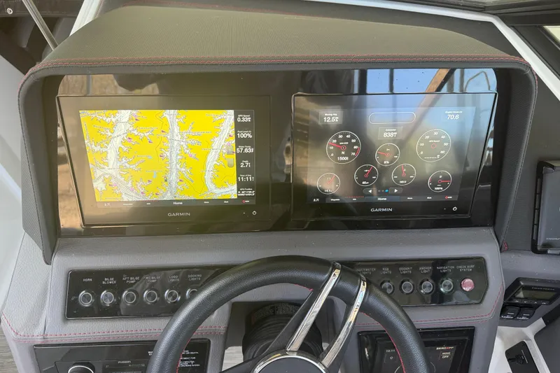 Slide: The Image of Dashboard of a 2022 Cobalt R8 Surf boat featuring Garmin navigation and control screens. - 3