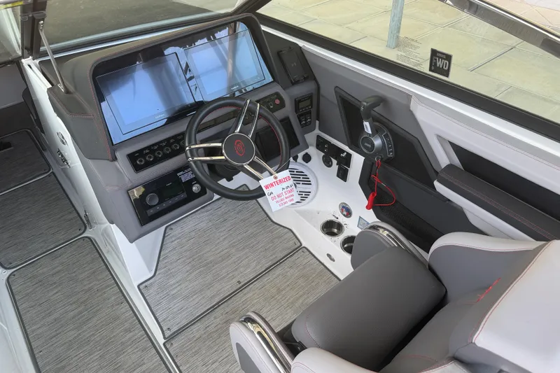 Slide: The Image of 2022 Cobalt R8 Surf boat cockpit with modern steering and dual screens. - 8