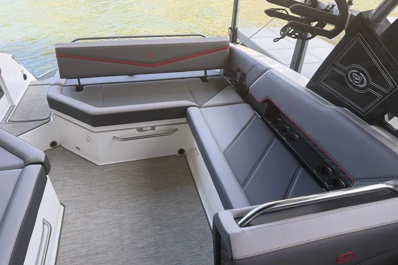 Slide: The Image of 2022 Cobalt R8 Surf boat interior with gray seating and cup holders. - 9