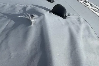 Slide: The Image of 2024 Nitro Z20 XL Pro boat cover with visible tear and black fittings. - 13
