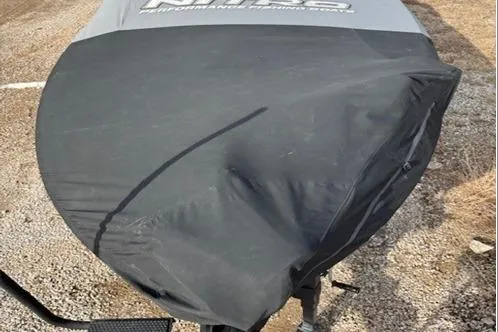 Slide: The Image of 2024 Nitro Z20 XL Pro boat with protective cover on gravel surface. - 14