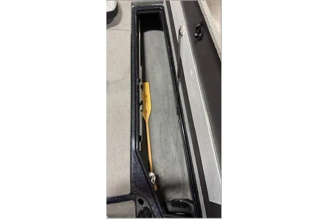 Slide: The Image of 2024 Nitro Z20 XL Pro boat storage compartment with paddle inside. - 6