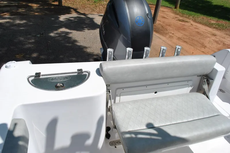 Slide: The Image of 2020 Sportsman Open 232 Center Console boat interior with seating and motor. - 16