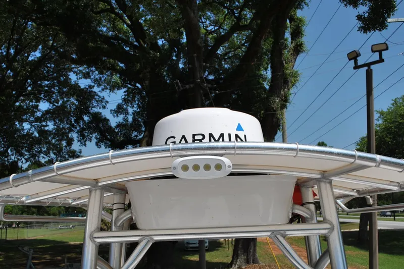 Slide: The Image of 2020 Sportsman Open 232 Center Console with Garmin radar, under clear blue sky. - 23