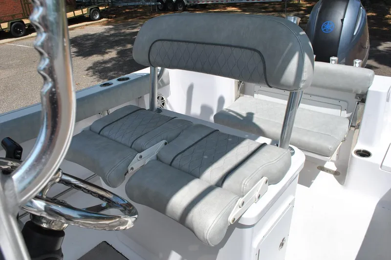 Slide: The Image of 2020 Sportsman Open 232 Center Console boat interior with gray cushioned seating. - 24