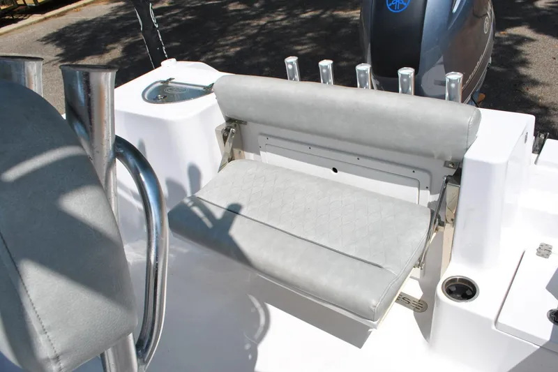 Slide: The Image of 2020 Sportsman Open 232 Center Console boat with cushioned seating and rod holders. - 25