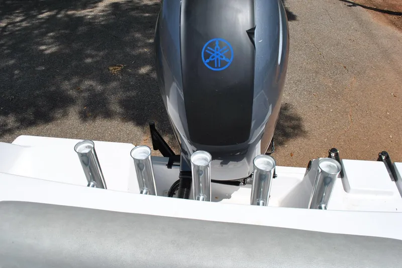 Slide: The Image of 2020 Sportsman Open 232 Center Console with Yamaha outboard motor and rod holders. - 26