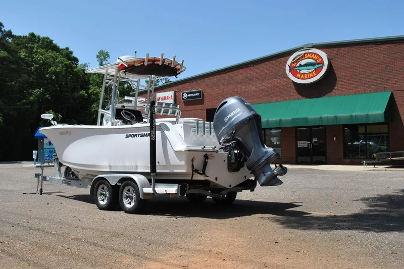 Slide: The Image of 2020 Sportsman Open 232 Center Console boat on trailer outside marine store. - 9
