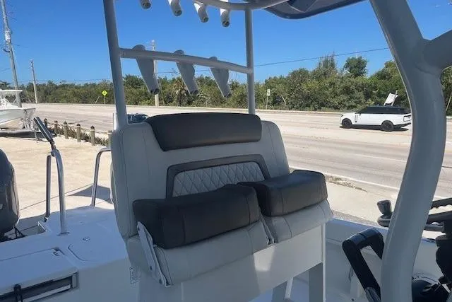 Slide: The Image of 2022 World Cat 235 CC boat interior with cushioned seating and rod holders. - 6