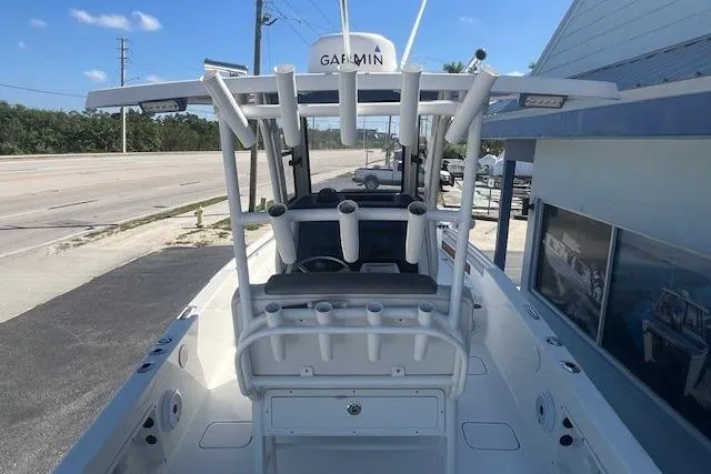Slide: The Image of 2022 World Cat 235 CC boat with rod holders and Garmin equipment, docked near a road. - 7